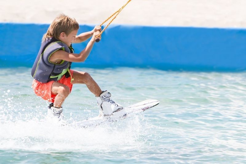 Young boy water skiing